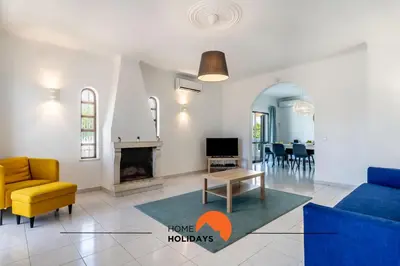 a living room with a couch and a fireplace at #072 Casa Longa by Home Holidays in Albufeira