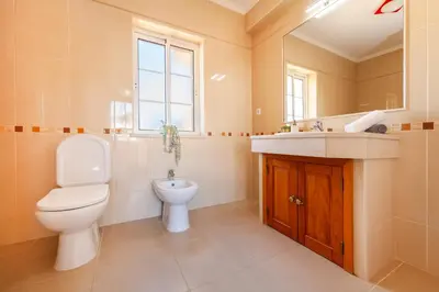 a bathroom with a toilet and a sink at Villa Dalia by Algarve Vacation in Almancil