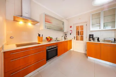 a large kitchen with wooden cabinets and a sink at Villa Dalia by Algarve Vacation in Almancil