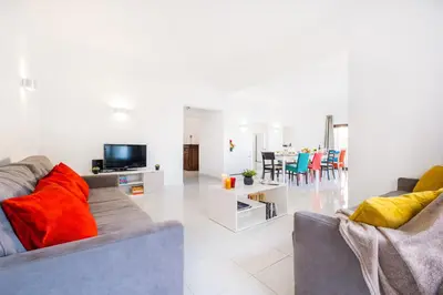 a living room with two couches and a tv at Villa Perola by Algarve Vacation in Albufeira