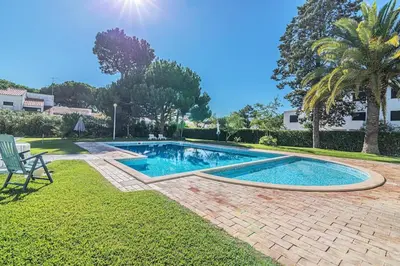 a swimming pool in the middle of a yard at Vilamoura - M M GARDEN - Magnifico T2 in Vilamoura
