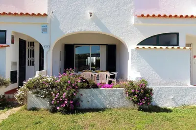 a white house with flowers in front of it at Charming Villa by SAPvillas in Vilamoura