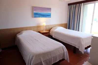 a hotel room with two beds and a window at Charming Villa by SAPvillas in Vilamoura