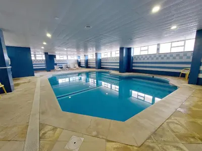 a large swimming pool in a building at Marina Mar Light by SAPvillas in Vilamoura