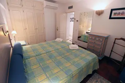 a bedroom with a bed and a dresser and a mirror at Marina Mar Sea Breeze by SAPvillas in Vilamoura