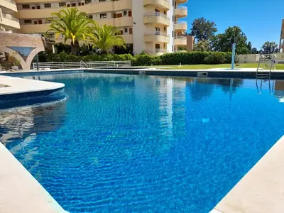 a large blue swimming pool in front of a building at Marina Mar Sea Breeze by SAPvillas in Vilamoura