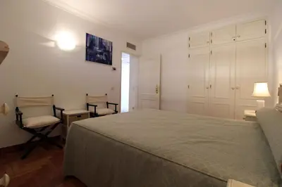 a bedroom with a bed and two chairs in it at Marina Mar Navigator by SAPvillas in Vilamoura