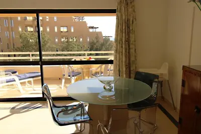 a glass table and chairs in a room with a window at Marina Mar Navigator by SAPvillas in Vilamoura