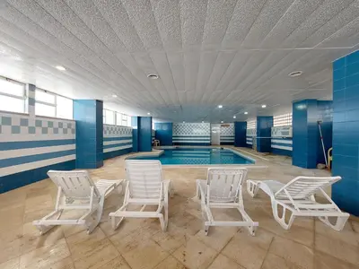 a swimming pool with white chairs and a swimming pool at Marina Mar Navigator by SAPvillas in Vilamoura