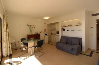 a living room with a table and a couch at Marina Mar Navigator by SAPvillas in Vilamoura