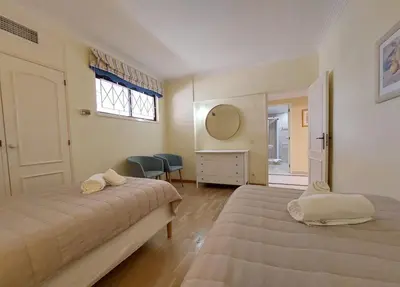 a bedroom with two beds and a desk and a window at Marina Mar Sailor by SAPvillas in Vilamoura