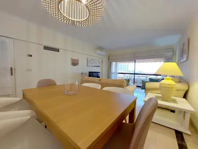 a living room with a wooden table and chairs at Marina Mar Sailor by SAPvillas in Vilamoura