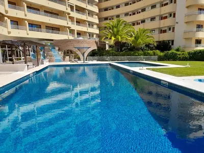 a bedroom with two beds and a table with a lamp at Marina Mar Ocean View by SAPvillas in Vilamoura