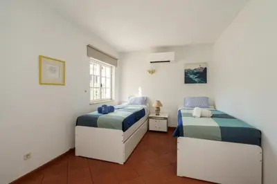 two beds in a room with white walls at Villa Mianas by SAPvillas in Vilamoura