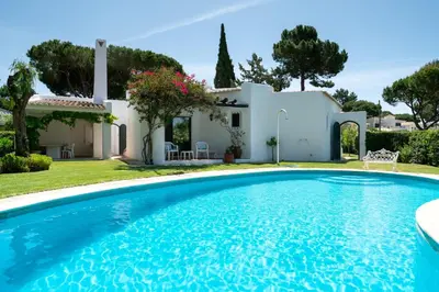 a villa with a swimming pool in front of a house at Villa Serendipity by SAPvillas in Vilamoura