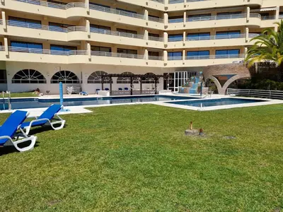 a large building with a lawn in front of a swimming pool at Marina Mar Marina by SAPvillas in Vilamoura