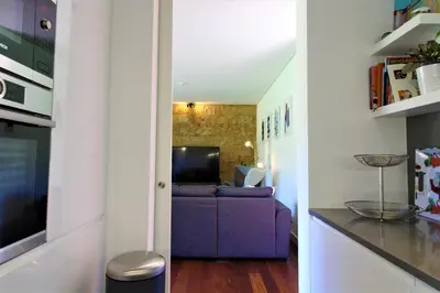 a living room with a purple couch in a room at L'Orangerie Green Garden by SAPvillas in Vilamoura