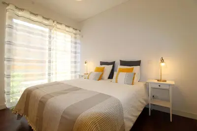 a bedroom with a large bed and a window at L'Orangerie Green Garden by SAPvillas in Vilamoura
