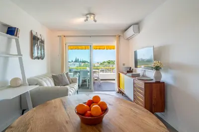a living room with a table with oranges on it at Albufeira Beach Apartment in Guia