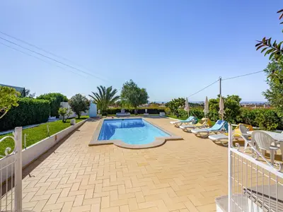 a swimming pool with chaise lounge chairs and a swimming pool at Holiday Home Vivenda Deolinda by Interhome in Albufeira
