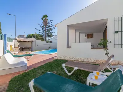 a backyard with a swimming pool and a house at Villa Villa Genoveva by Interhome in Albufeira