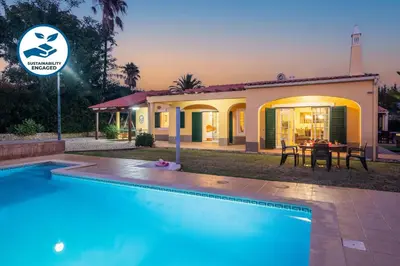 a villa with a swimming pool in front of a house at Villa Bali by Algarve Vacation in Albufeira