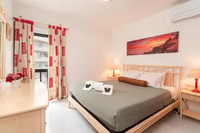 a bedroom with a bed with two towels on it at Centralgarve - Great, Bright 2-bedroom Flat in the Center of Vilamoura -Topázio in Vilamoura