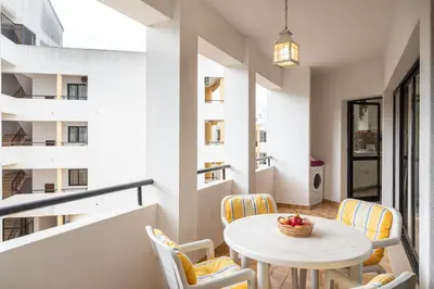 a small dining room with a table and chairs at Centralgarve - Great, Bright 2-bedroom Flat in the Center of Vilamoura -Topázio in Vilamoura
