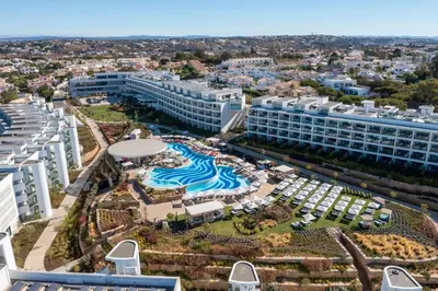 a room with a table and a laptop on a wall at W Residences Algarve in Albufeira