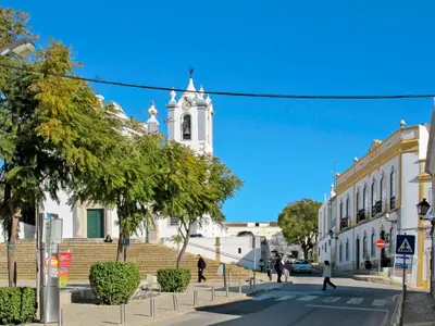 a city street with a white building with a clock tower at Holiday Home Isaurinda by Interhome in Faro
