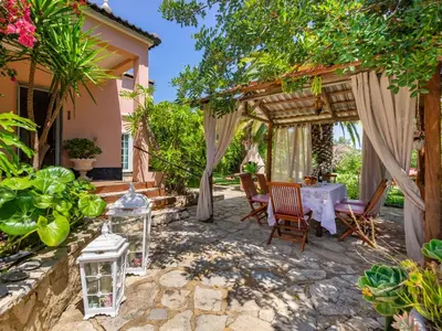 a patio with a table and chairs under a pergola at Holiday Home Isaurinda by Interhome in Faro