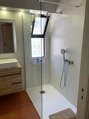 a shower with a glass door in a bathroom at Solar dos Pinheiros LC 303 in Quarteira