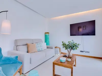 a living room with a couch on a balcony at Vale do lobo, 'Golf by the Pool' 2 bedroom apartment in Vale do Lobo