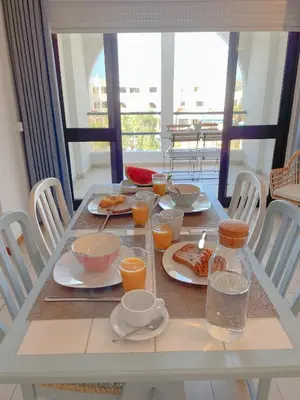 a table with plates of food and glasses of orange juice at Apartamentos Ninho das Gaivotas in Albufeira
