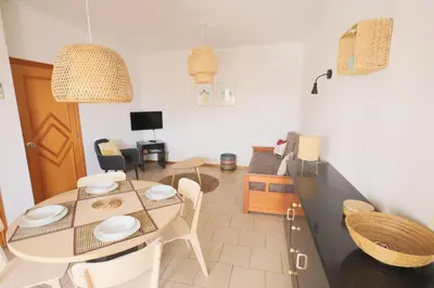 a kitchen and dining room with a table and chairs at Apartamentos Ninho das Gaivotas in Albufeira