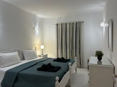 a bedroom with a large bed with a blue blanket at Sta. Eulalia Mar A36 in Albufeira