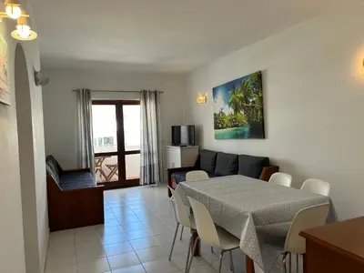 a living room with a table and a couch at Sta. Eulalia Mar A36 in Albufeira
