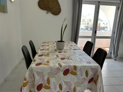 a table with a table cloth with a potted plant on it at Sta. Eulalia Mar A29 in Albufeira