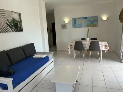 a living room with a couch and a table with chairs at Sta. Eulalia Mar A29 in Albufeira