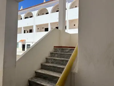a staircase leading to a white building with a yellow railing at Sta. Eulalia Mar A29 in Albufeira