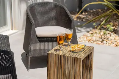 two glasses of beer on a wooden table with a chair at Villa Flamingo - Quinta do Mar in Almancil