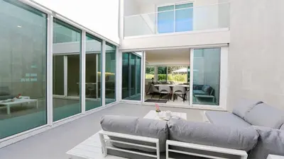 a living room with a couch and a table at Villa Sadler- Clever Details, Central Vilamoura, Sleeps 6, luxury, walking distance in Vilamoura