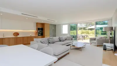a living room with a couch and a table at Villa Sadler- Clever Details, Central Vilamoura, Sleeps 6, luxury, walking distance in Vilamoura
