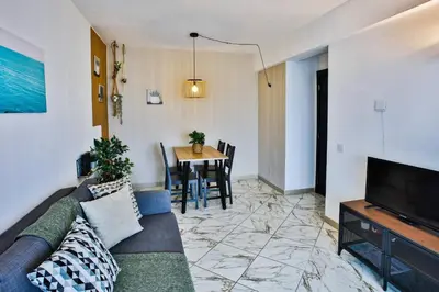 a living room with a couch and a table at Go4Portugal - Lagoa - Apartment 3 min from beach with airco and balcony in Quarteira