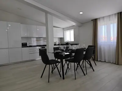 a dining room with a black table and chairs at Alojamento King´s Village in Albufeira