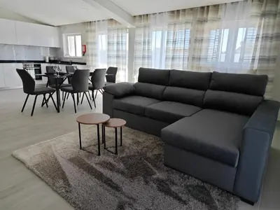 a living room with a couch and a table at Alojamento King´s Village in Albufeira