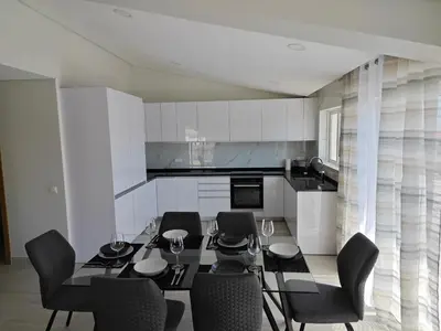 a kitchen with a dining room table and chairs at Alojamento King´s Village in Albufeira