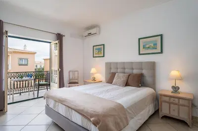 a bedroom with a bed and a balcony at Pedra dos Bicos by Intiholidays in Albufeira