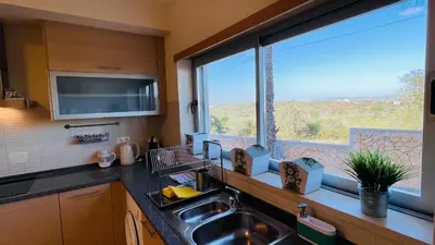 a kitchen with a sink and a large window at Santa Maria C by Check-in Portugal in Albufeira