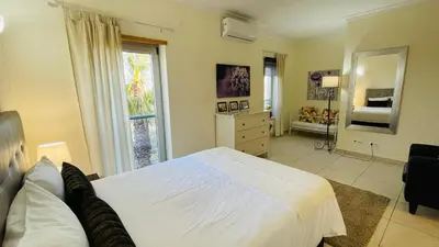 a bedroom with a white bed and a large window at Santa Maria C by Check-in Portugal in Albufeira
